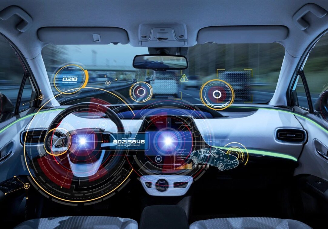 A car dashboard with the steering wheel and infotainment system.