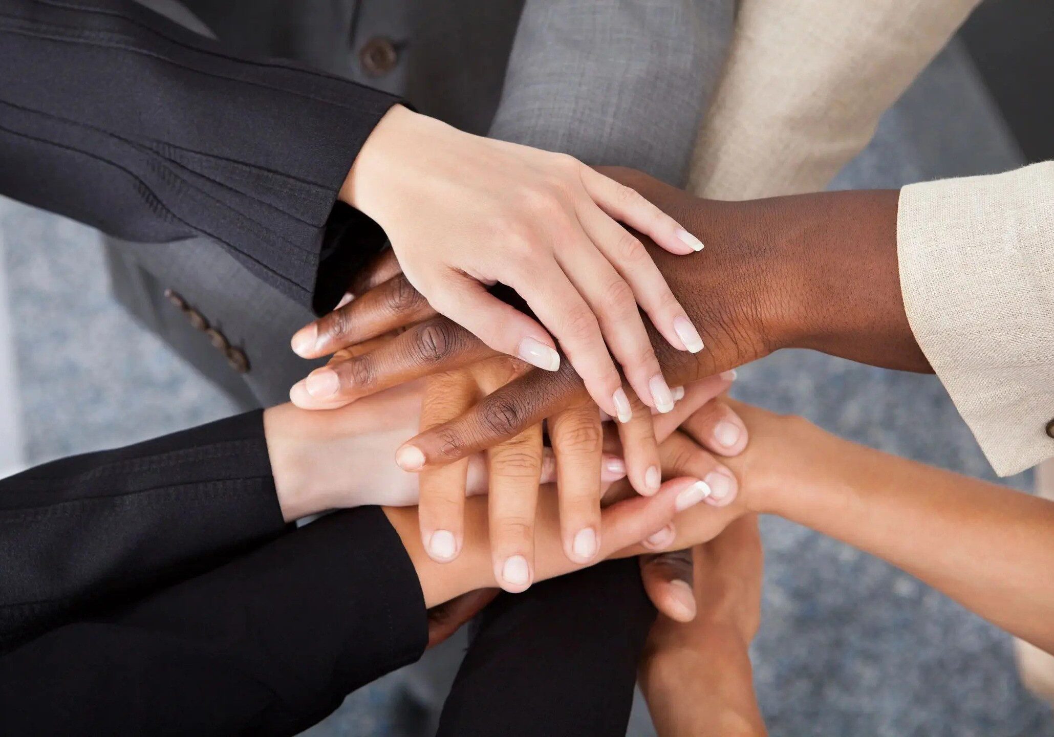 A group of people with their hands together.